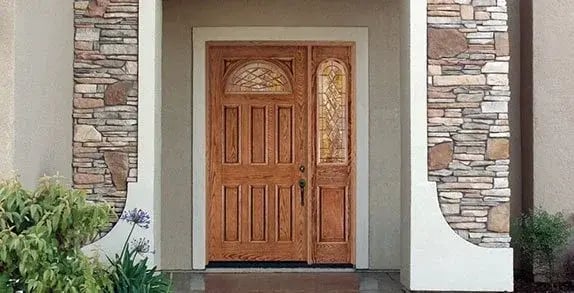 Wood entry door with decorative glass and a matching sidelight