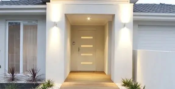 Entry door with horizontal glass inserts beneath a covered porch