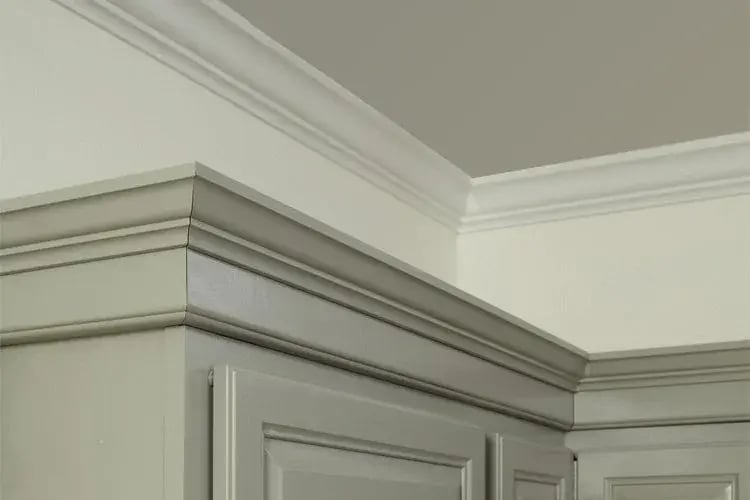 Layered crown moulding above painted cabinetry