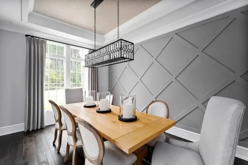 Dining room with geometric wall trim and a coffered ceiling