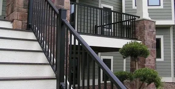 Black metal railings along exterior steps and a porch