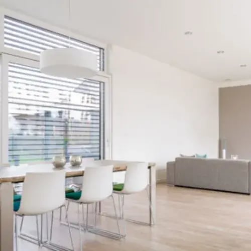 Dining area with large windows and horizontal blinds
